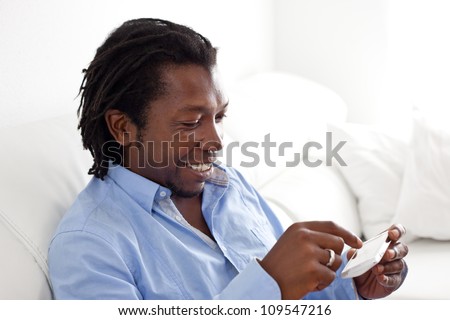 Stylish black man with a smart phone.
