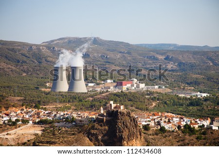The spanish typical village of Cofrentes, with its castle in the foreground and its nuclear plant in the background.