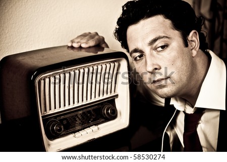 Retro - close up of dressed up man listening to old radio