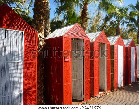 Red cabins at a tropical resort.