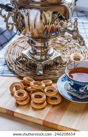 An old russian samovar with group of dry-bread rings and a vintage cup of tea