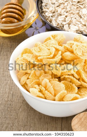 bowl of corn and oat on wood background