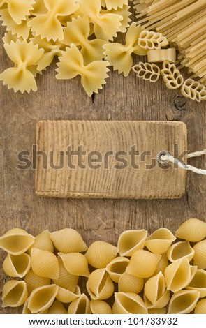 raw pasta and price tag label on wooden background