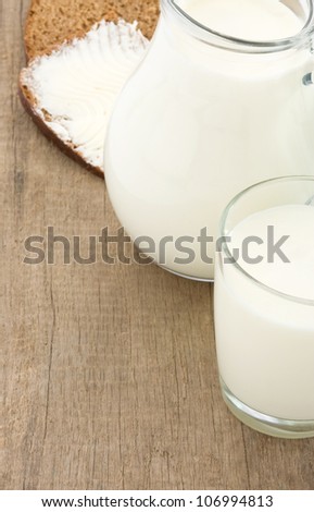 milk products and cheese at wooden background