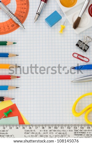 school supplies on  checked notebook paper