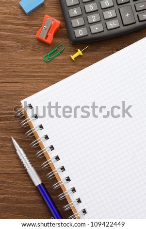school supplies and checked paper notepad