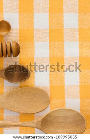 wood utensils at table checked napkins background