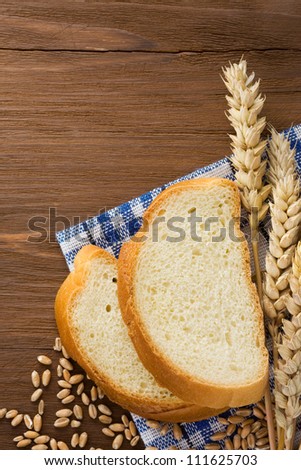 sliced bread and ears of wheat on napkin