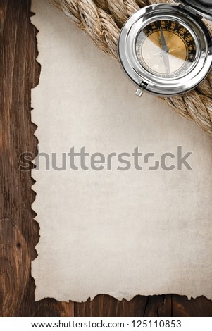 ropes and compass on old vintage ancient paper background texture