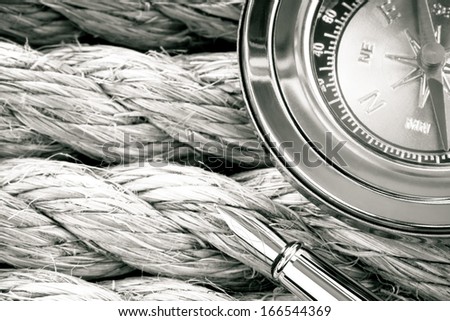 compass with ink pen on ship ropes