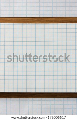 checked note paper on wooden background