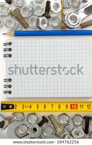 metal construction hardware tool and blank notebook