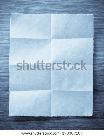 folded note paper on wooden background
