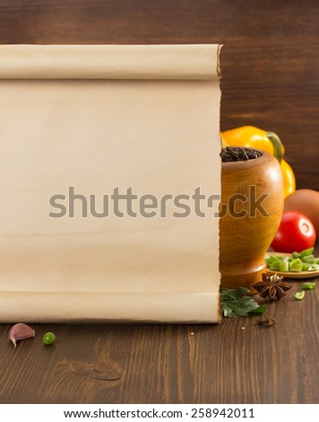 food spice and old paper on wooden background