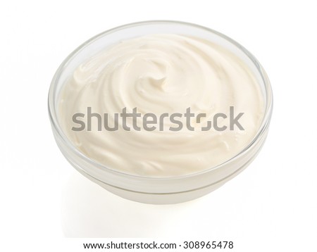 sour cream in bowl on white background