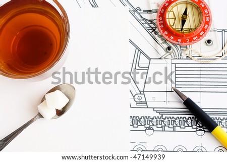 compass, pen and tea at draft