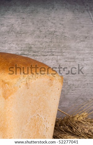 wheat ear and bread near the wall