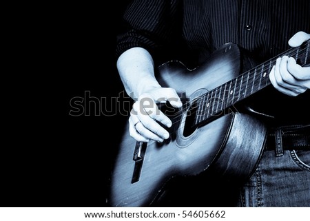 man playing guitar in blue tint