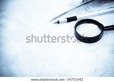 magnifying glass and feather closeup