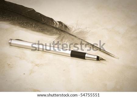 sepia image of feather and pen