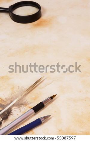 pen and feather at paper
