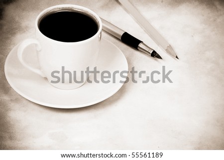 sepia image of cup of coffee and office accessory