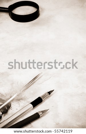 sepia image of pens at paper