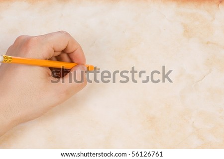 hand with pencil at wall