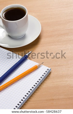 coffee, notepad and pens on table