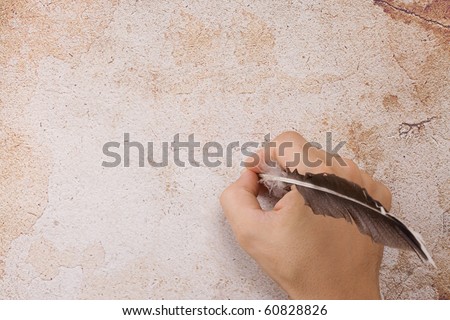 writing male hand with feather