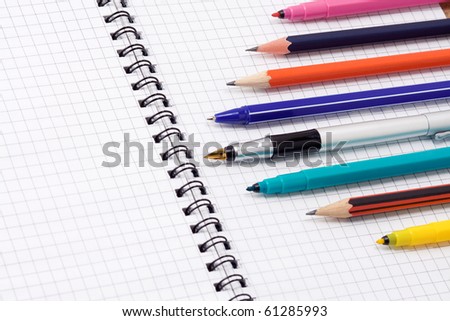 set of pens and pencils on pad