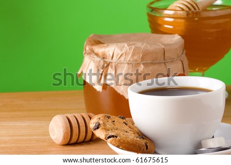 coffee, honey and cookies on table