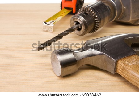 hammer and tape measure on wood brick