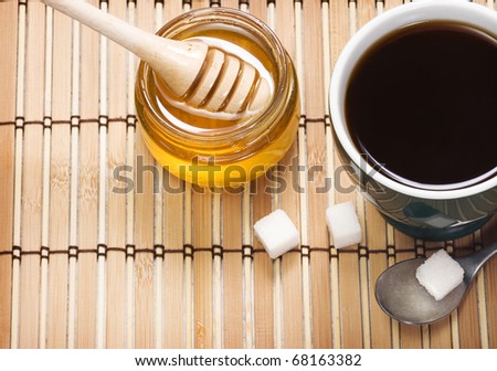 pot of honey and coffee on wood