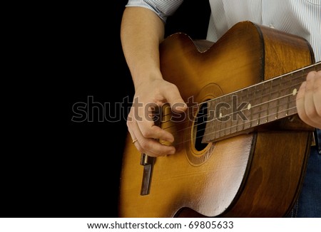 man playing guitar on black background