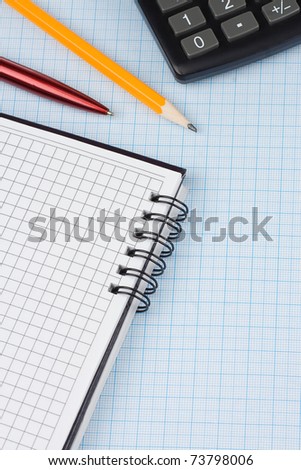 school accessories, dollars and checked notebook on graph grid paper