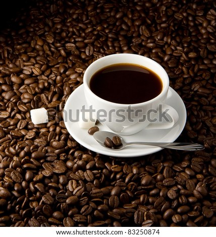 cup of coffee and roasted beans