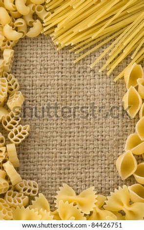 raw pasta on sack burlap background texture