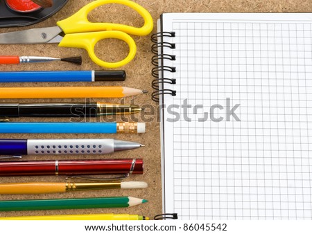 back to school and accessories on checked notebook at wood texture