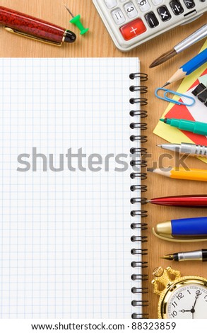 back to school concept and checked notebook on wood background