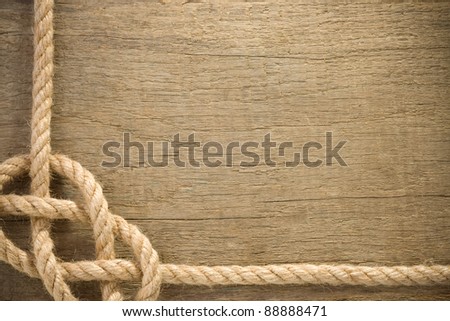 ship ropes with knot on wood background texture