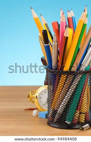 back to school concept and office supplies on blue background