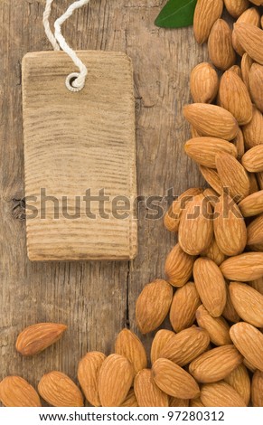 nuts almond fruit and tag label on wood background texture