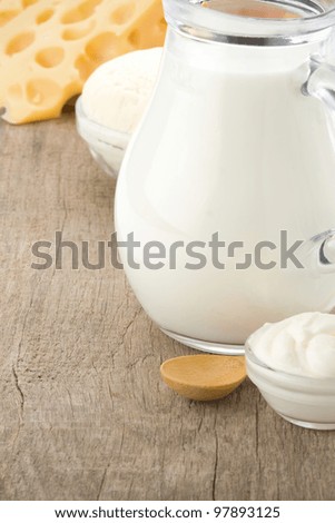 swiss cheese and milk products on wood background