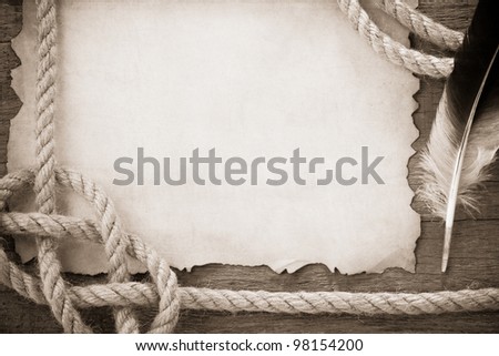 ropes and feather on old vintage ancient paper background texture