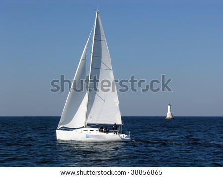 Sailing boat and lighthouse