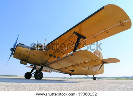 Old yellow airplane with double wings