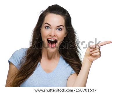 A Very Happy And Surprised Woman Pointing To Copy-Space. Isolated On White.