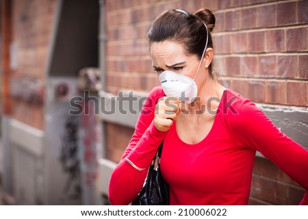 Woman wearing face-mask coughing