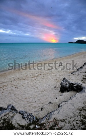 Sunset over a beach on the island of Bora Bora in Tahiti.